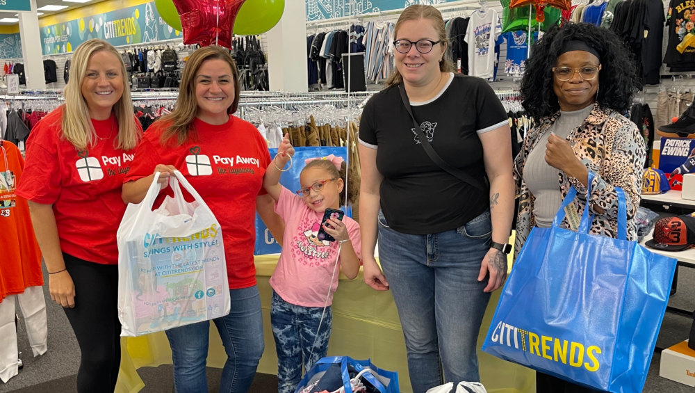 Pay Away volunteers surprise mom and daughter with paid off layaway items.