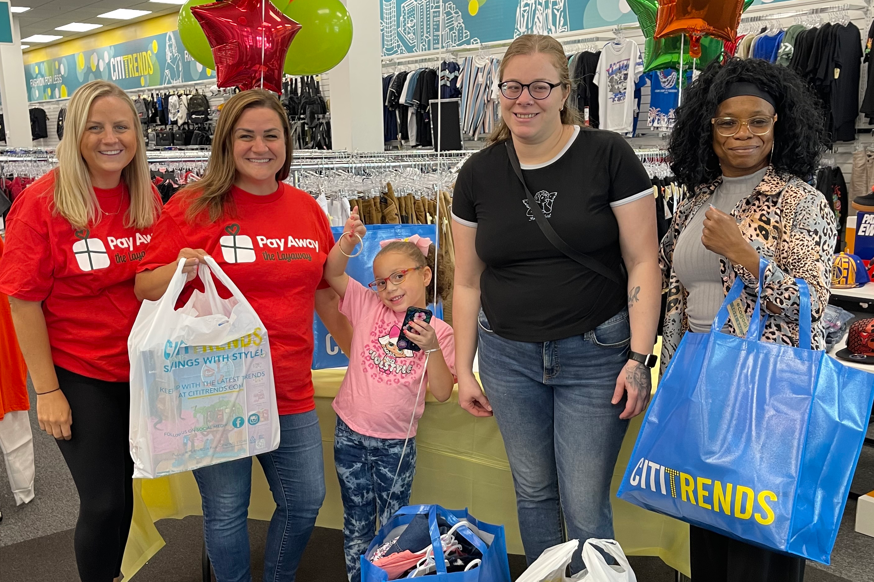 Pay Away volunteers surprise mom and daughter with paid off layaway items.