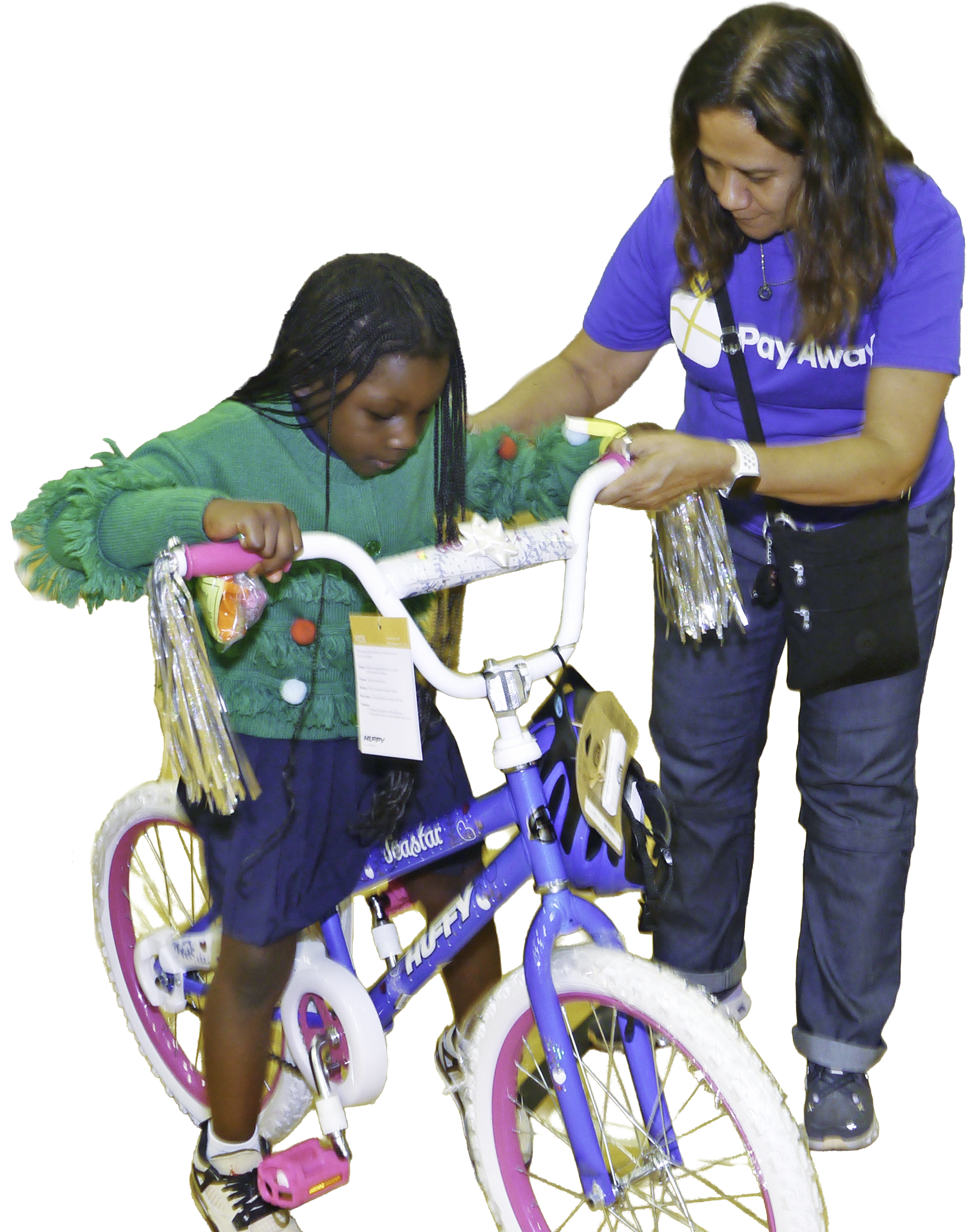 Pay Away volunteer assiting a girl with a new bike